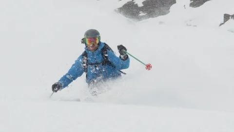 Elite skier cutting through fresh powder on a remote mountain Stock Footage 113242590