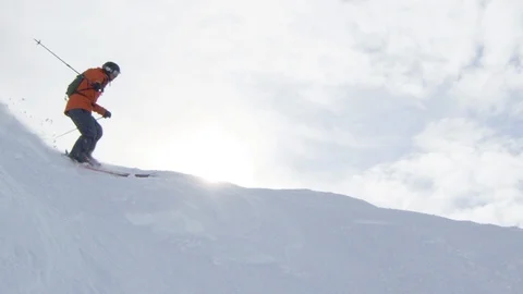 Elite skier cutting through fresh powder on a remote mountain Stock Footage 113242761