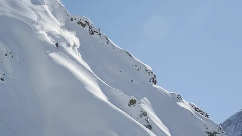 Elite skier cutting through fresh powder on a remote mountain Stock Footage 113244597