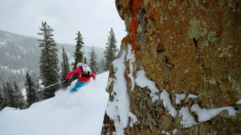 Elite skier cutting through fresh powder on woodsy slope Stock Footage 113264007
