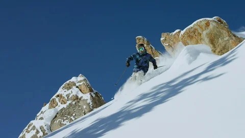 Elite skier cutting through powder snow on a remote slope Stock Footage 113263173