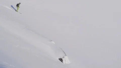 Elite skier jumping off of cliffs on a remote mountain Stock Footage 113225496