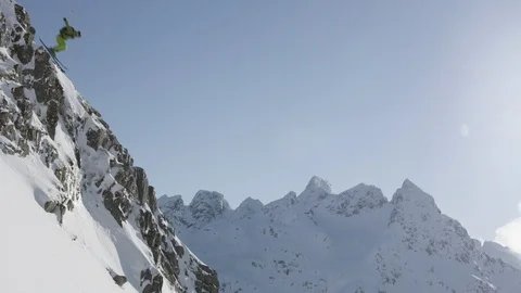 Elite skier jumping off of cliffs on a remote mountain Stock Footage 113225600