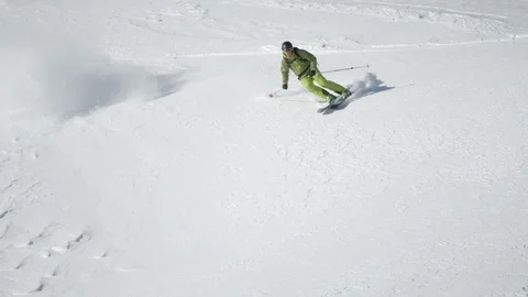 Elite skier jumping off of cliffs on a snowy and rocky mountain face Stock Footage 113224494