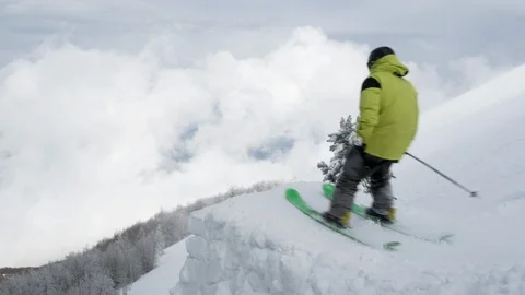 Elite skier landing a backflip off a trailside jump into powder snow Stock Footage 113220196