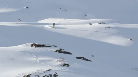 Elite skier making first tracks in fresh powder on a remote mountain Stock Footage 113225970