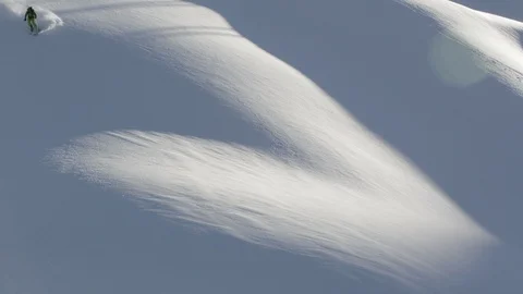 Elite skier making first tracks in fresh powder on a remote mountain Stock Footage 113226105