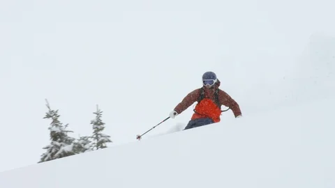 Elite skier making turns while skiing on snowy mountain slope Stock Footage 116785708