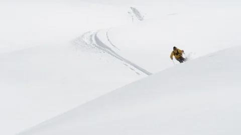 Elite skier outing through rolling hills of fresh powder on a remote mountain Stock Footage 113217439