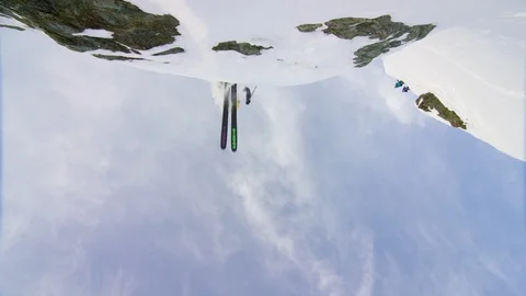 Elite skier performing a backflip over the camera on a remote mountain Stock Footage 113251424