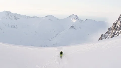 Elite skier performing a front flip off of remote mountain cliff Stock Footage 113226051