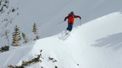 Elite skier performing grab trick while jumping from snowy mountain Stock Footage 116785684