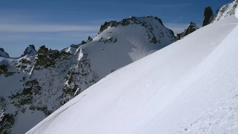 Elite Skier skiing down the mountain slope on a sunny day Stock Footage 116789299