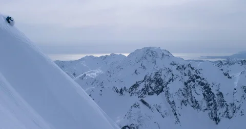 Elite skier skiing down steep remote mountainside Stock Footage 111992689