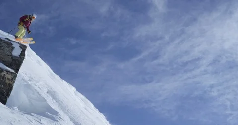 Elite skier skiing down steep remote mountainside Stock Footage 111996334