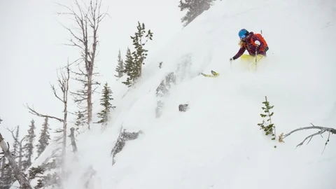 Elite skier skiing downhill during a snowfall Stock Footage 116745776