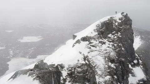 Elite skier skiing from the summit of a remote mountain Stock Footage 113227960