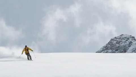 Elite skier speeding down powder covered mountain slope Stock Footage 113217718