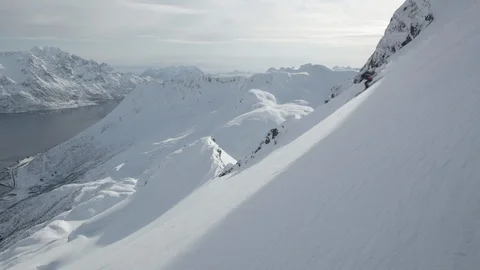 Elite skier speeding down remote mountainside Stock Footage 113226243