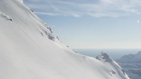 Elite skier speeding down a remote mountain face Stock Footage 113229557