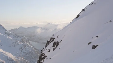 Elite skier speeding down a rocky and snowy mountain face Video stock 113225736