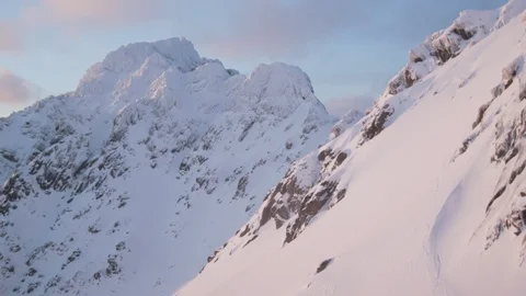 Elite skier speeding down a snowy mountainside at sunset Stock Footage 113228538