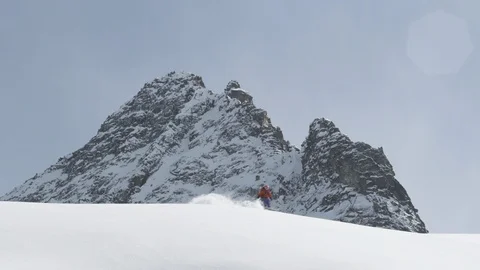 Elite skier speeding through fresh powder on mountain slope Stock Footage 113217646
