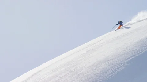 Elite skier speeding through fresh powder on a remote mountain Stock Footage 113252532