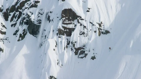Elite skier speeding through fresh powder on a remote mountain Stock Footage 113252685