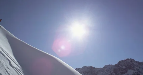 Elite skier spraying powder while cruising down a remote mountain Stock Footage 111994067