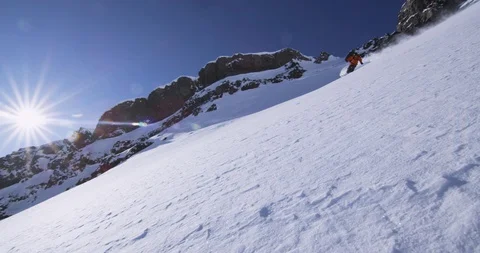 Elite skier tears through snow on a a remote mountainside Stock Footage 111995634