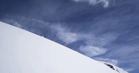 Elite skiers cruising down remote mountainside Stock Footage 111996586