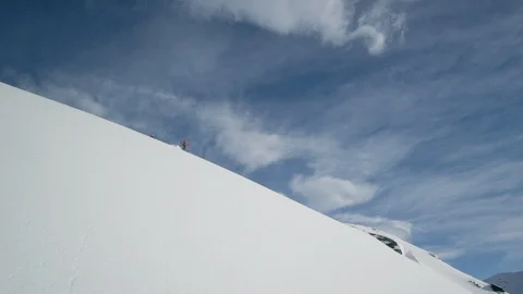 Elite skiers cruising down a remote mountain Stock Footage 113258437