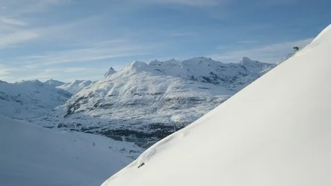 Elite skiers cruising down a remote mountain Stock Footage 113258601