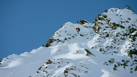 Elite snowboarder cruising down the slopes of a snowy mountain Stock Footage 113262871