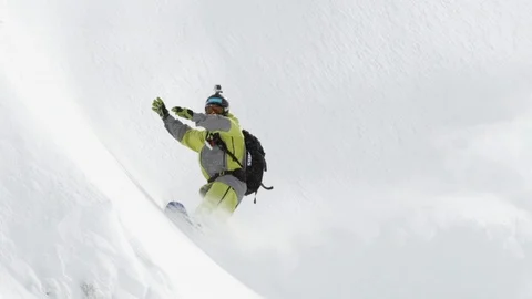 Elite snowboarder cutting through fresh powder Stock Footage 113237182