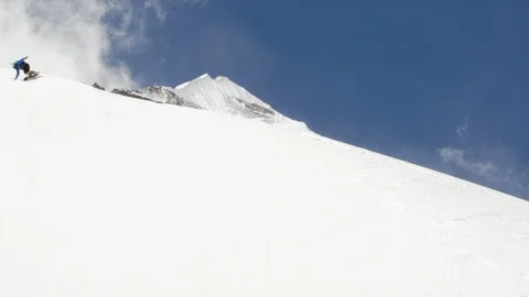 Elite snowboarder cutting through fresh powder on a remote mountain Video stock 113256089