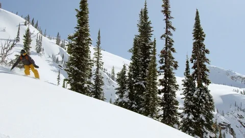 Elite snowboarder jumping and doing a turn in powder on the snow mountain Stock Footage 116788826