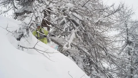 Elite snowboarder jumping high during a snow storm Stock Footage 113236535