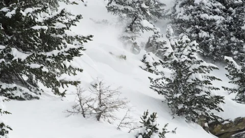 Elite snowboarder jumping off snowy ledge on mountain slope Stock Footage 113237408