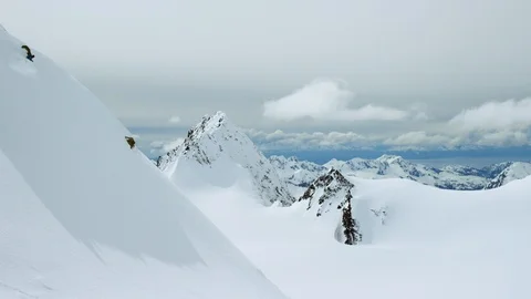 Elite snowboarder performing tricks on a remote mountain Video stock 113261199