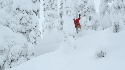 Elite snowboarder sliding through deep powder snow Stock Footage 116783199