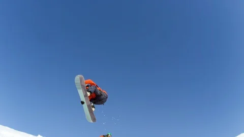 Elite snowboarders jumping over the camera Stock Footage 113266982