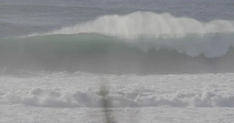 Elite surfer riding big waves in wild ocean in slow motion in Nazare Video stock 160767613