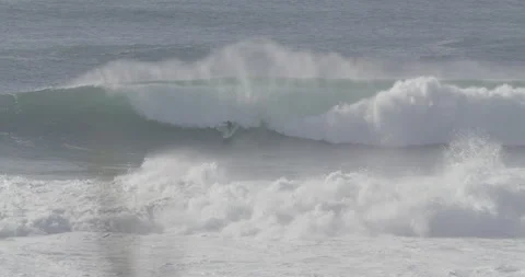 Elite surfers riding ocean waves on surfboards on sunny day in slow motion Stock Footage 160776773