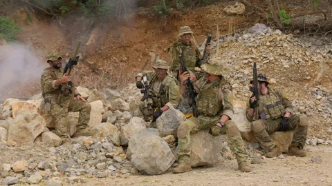 Elite team of special forces soldiers in full tactical gear pose together Stock Footage 342618971
