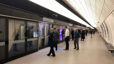 The Elizabeth underground train platform. Passengers waiting for doors to open. Stock Footage 195438893