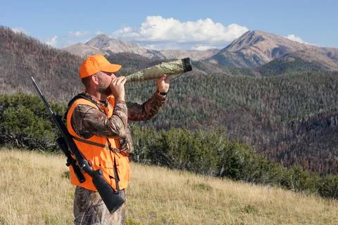 Elk hunter bugling in the mountains Stock Photos