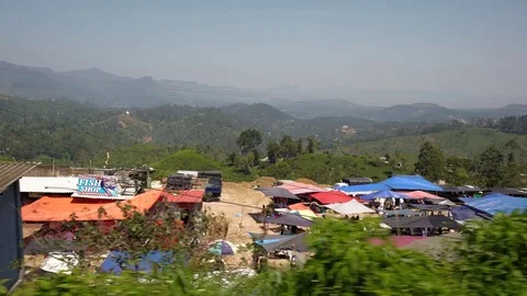 ELLA, SRI LANKA - MARCH 2016: Train passing small villages with houses and Stock Footage 76133418