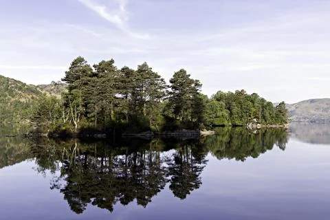 Ellen's Isle reflected in Loch Katrine. Southern Highlands of Scotland. Stock Photos